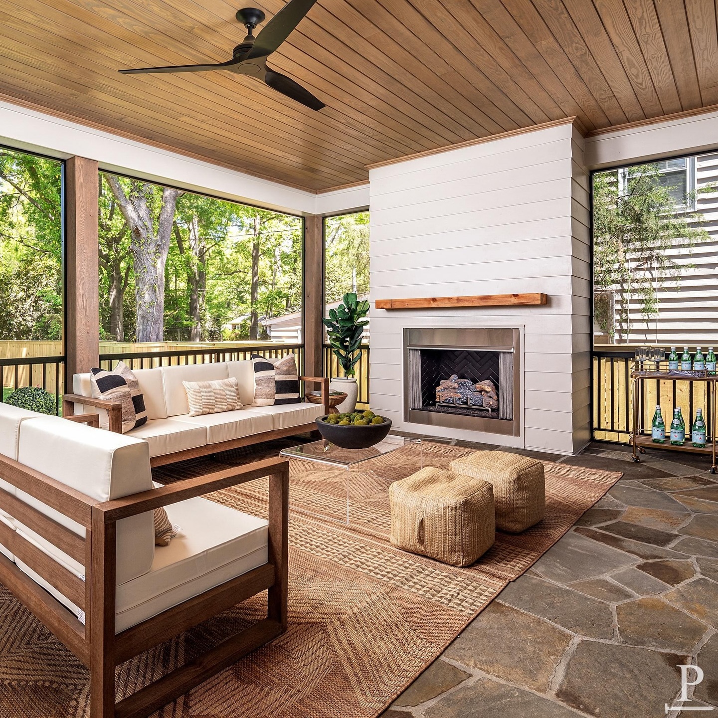 Enjoy seamless indoor/outdoor living on our screened-in back porch featuring sliding glass doors, a cozy gas fireplace, stone flooring, and a stunning wood tongue-and-groove ceiling🔥🌿 

This Rear Porch is featured in our ‘Kenmore’ Pike Home Plan. Use the Link in our bio to check out our current projects & home plans 📲 #pikeproperties 
•
•
⚒️ @pikeproperties
📸 @joepurvisphotos