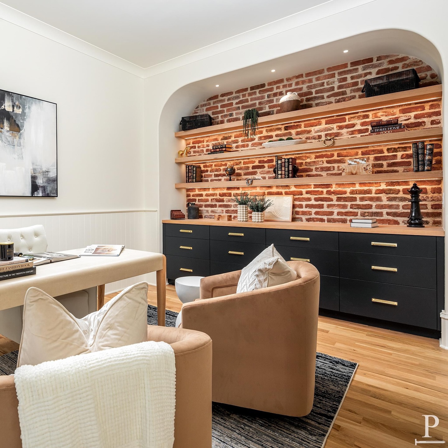 Workspace goals! This home office features oversized windows, custom built-ins, a chic brick wall accent, and cabinets painted in @benjaminmoore Black Beauty 🖤

This Home Office is featured in our ‘Kenmore’ Pike Home Plan. Use the Link in our bio to check out our current projects & home plans 📲 #pikeproperties 
•
•
⚒️ @pikeproperties
📸 @joepurvisphotos
🛋️ @stageofdesigns