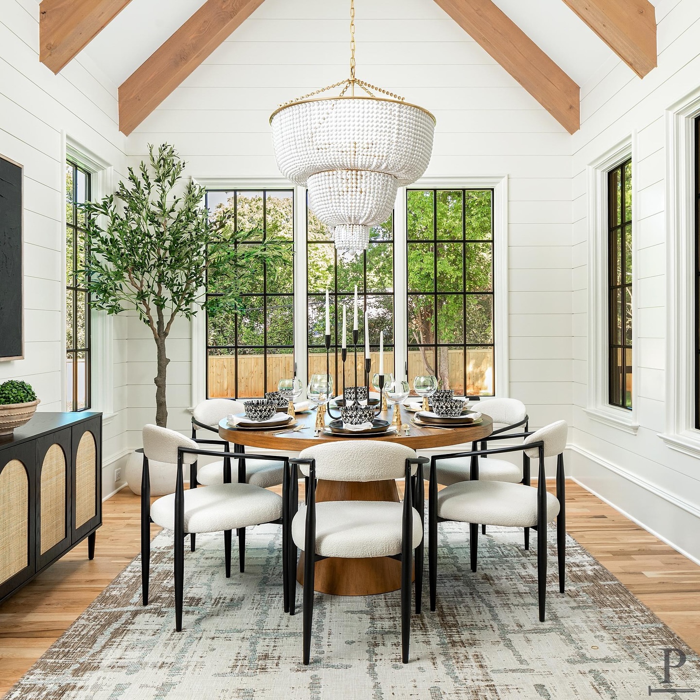 Dining in style 🍽️ This dining room boasts a vaulted ceiling, white oak beams, shiplap walls, and a stunning Visual Comfort chandelier✨

This Dining Room is featured in our ‘Kenmore’ Pike Home Plan. Use the Link in our bio to check out our current projects & home plans 📲 #pikeproperties 
•
•
⚒️ @pikeproperties
📸 @joepurvisphotos