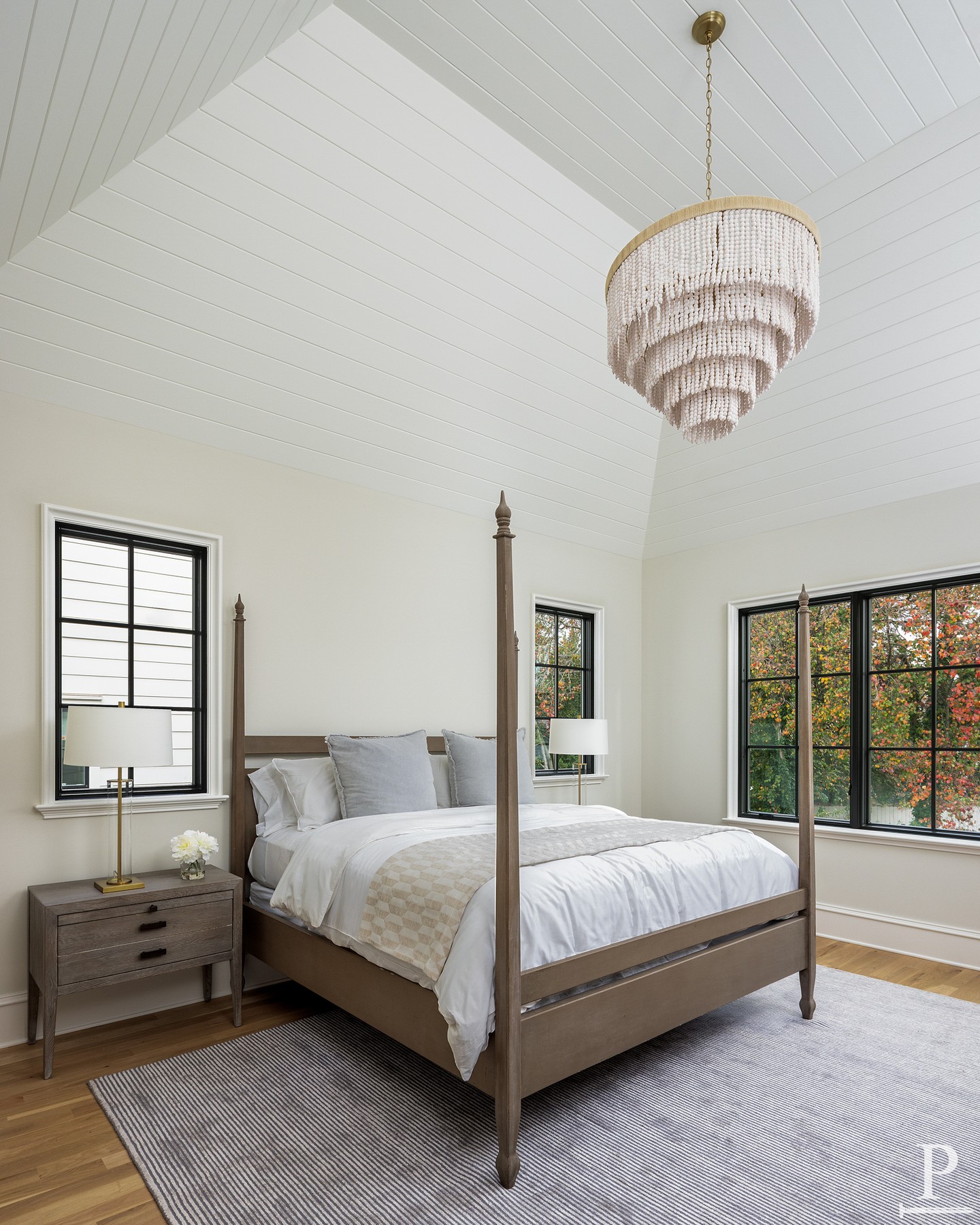 Vaulted ceilings, shiplap details, and warm natural wood accents make this primary suite a serene retreat ✨ Where comfort meets timeless design.