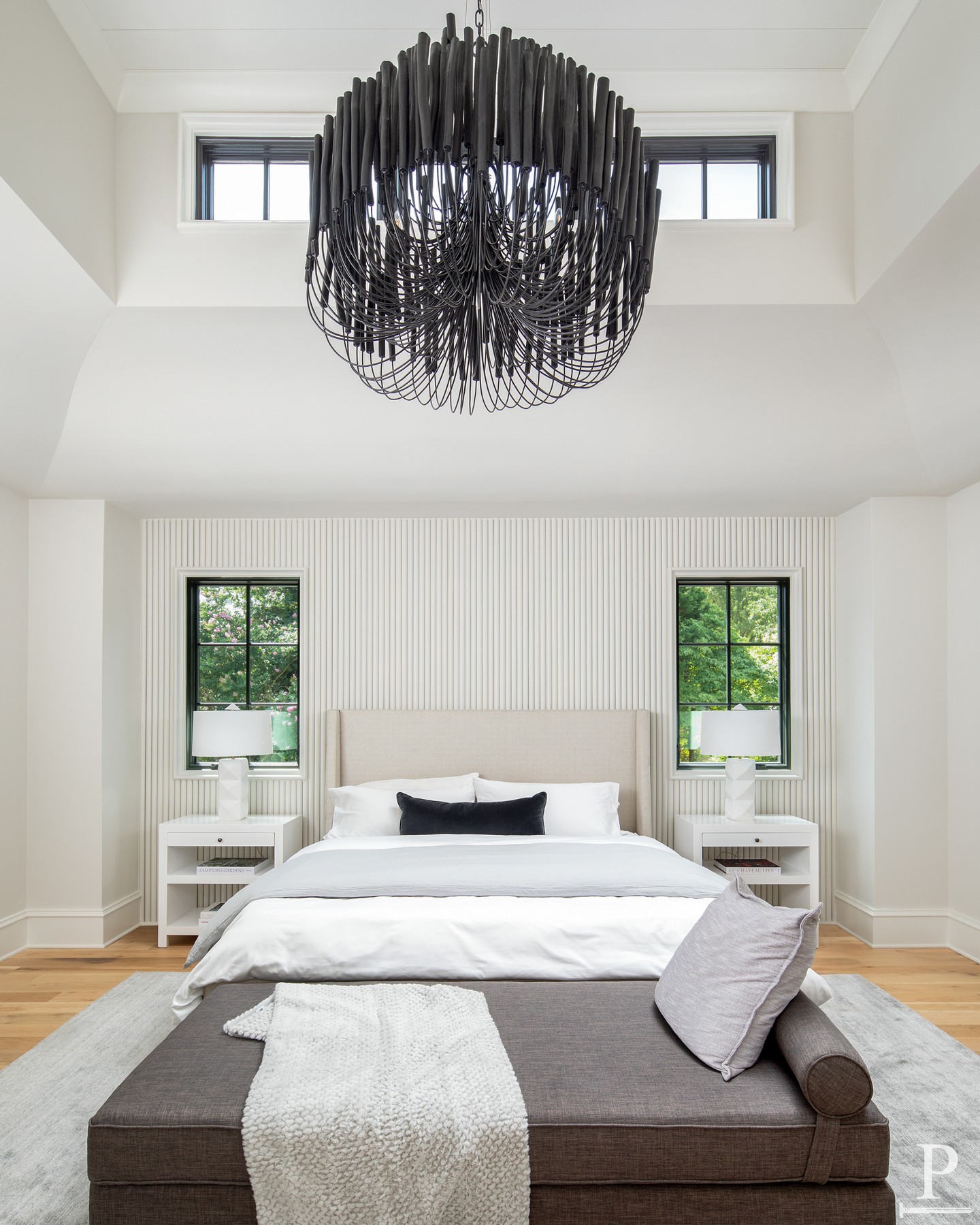 The primary suite that has it all.

A sculptural chandelier anchoring the bedroom, a fluted accent wall, black steel windows, and a walk-in closet with its own island. Every detail designed to feel like a retreat.
