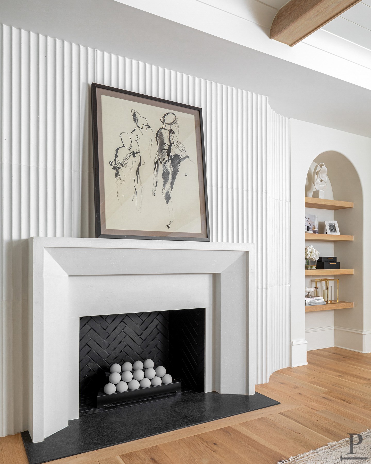 This great room is anchored by a custom fireplace surround, framed by a fluted detail wall that adds texture without stealing focus. 🫧

At Pike, we love subtle drama.