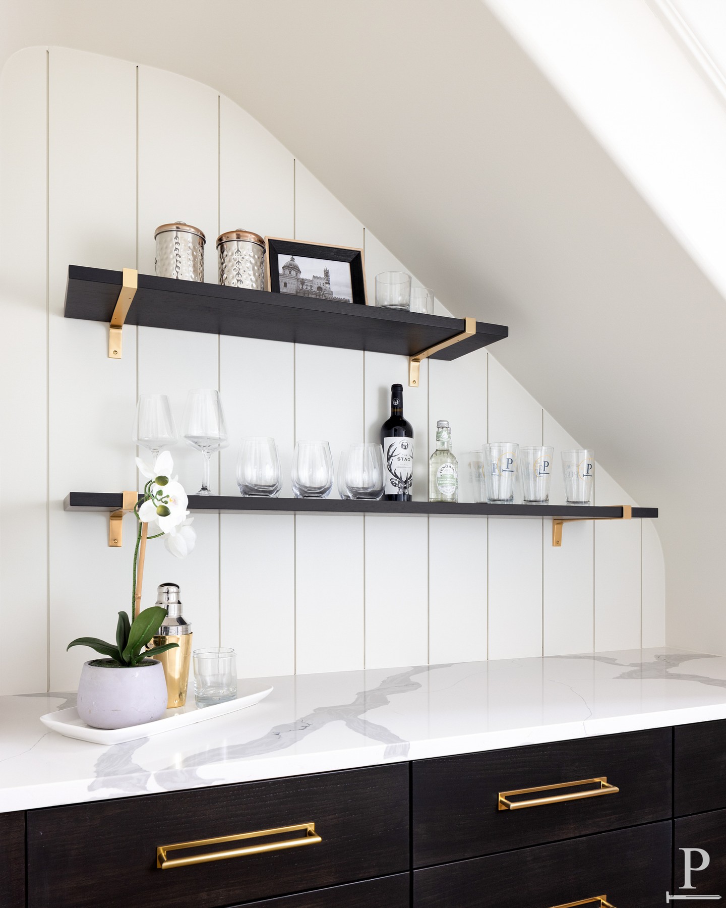 Under the stairs, but never wasted. 🥃

A full bar built into an unused corner, complete with open shelving and storage for the essentials.

Proof that every square foot can earn its keep.