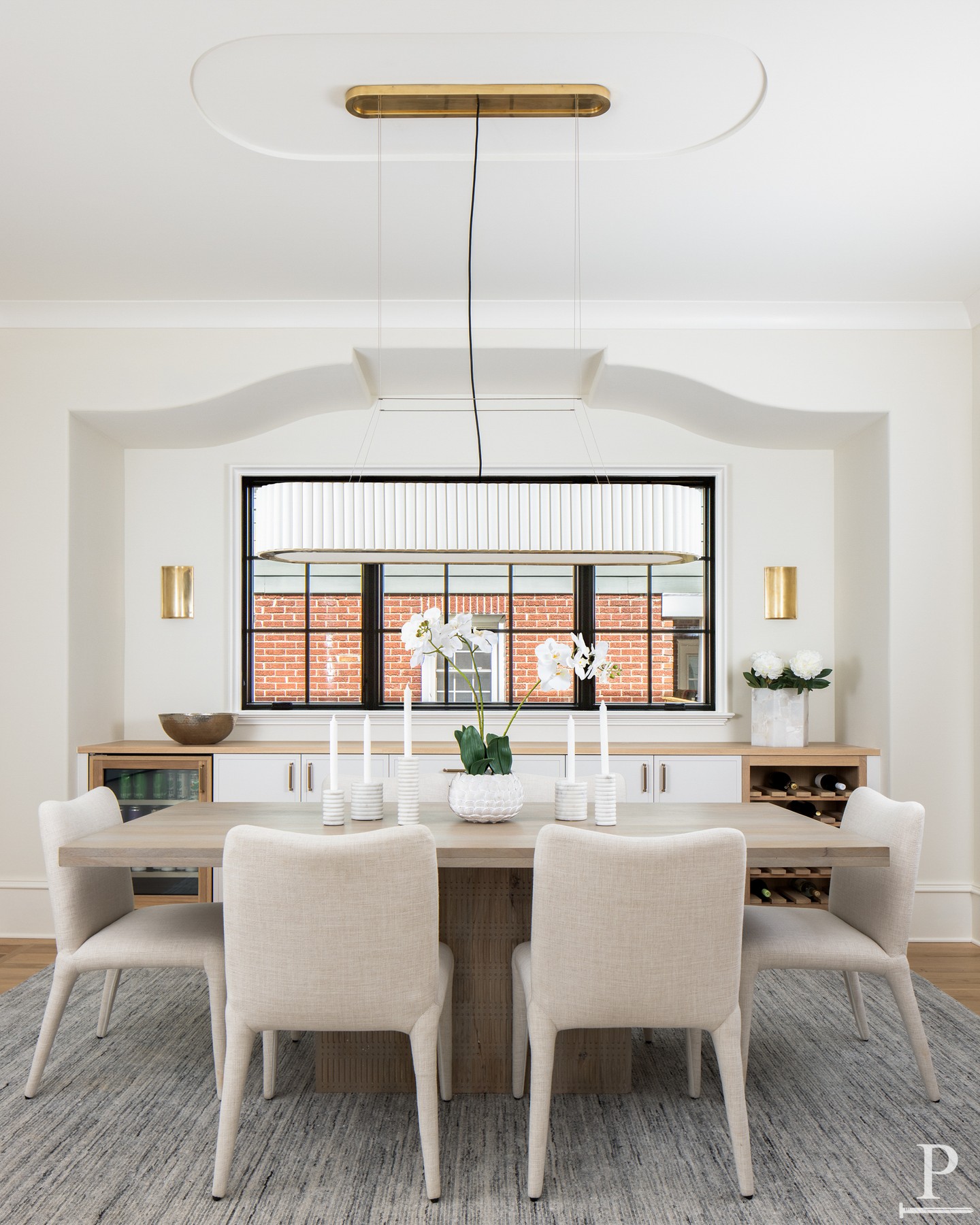 An elegant built-in anchors this dining room, complete with a beverage fridge, wine storage, and a casement window detail that gives it a shape all its own. 🥂