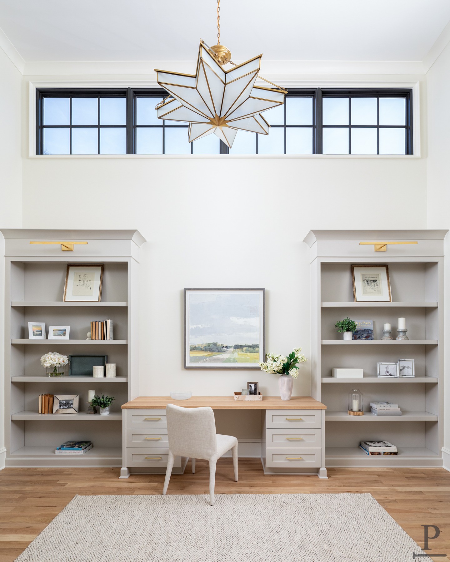 A home office built to gather and inspire, with tall windows, custom built-ins, and a statement fixture that draws the eye up. ⭐