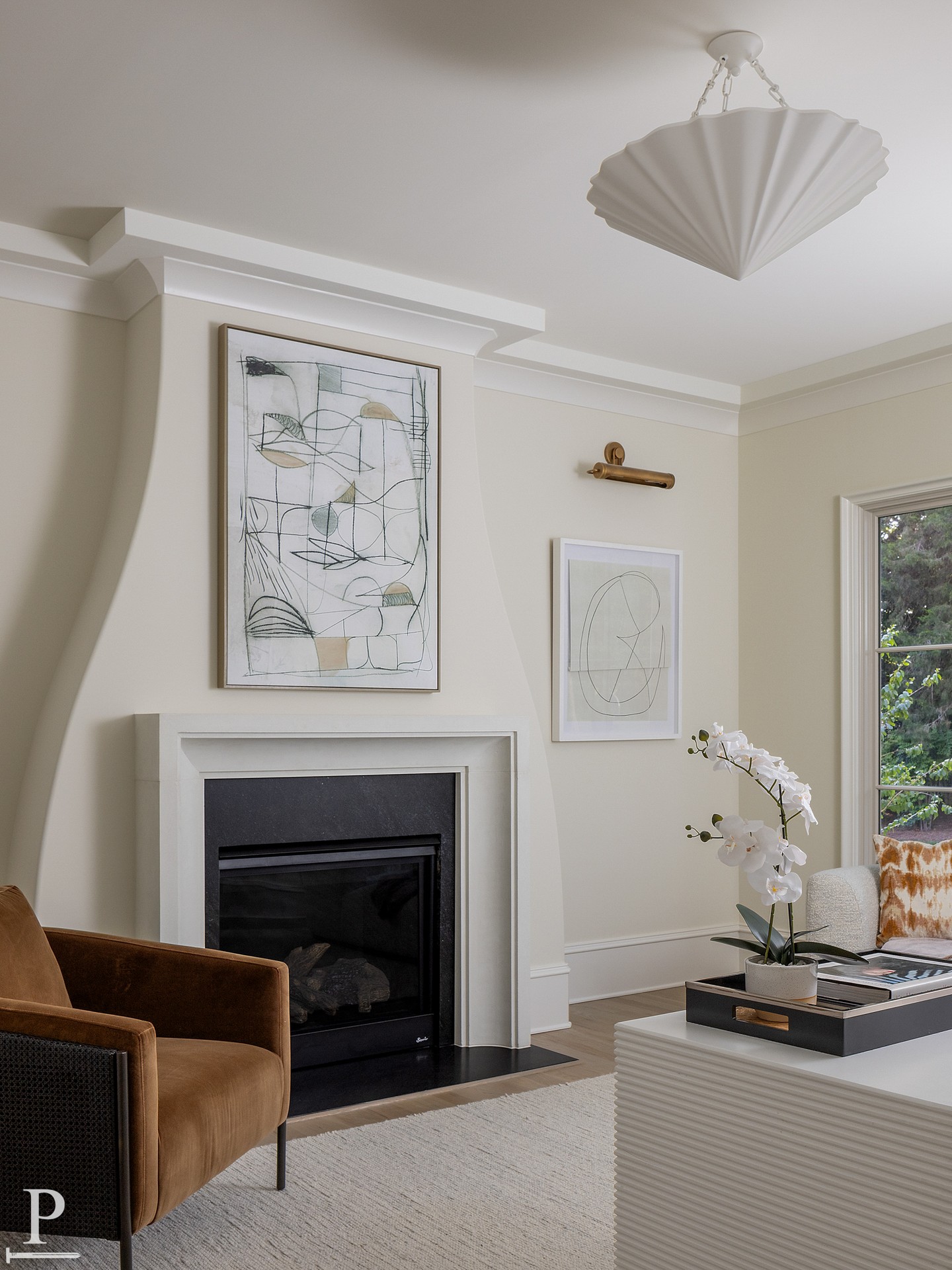 A fireplace that's more sculpture than mantel. The rounded corner bead detail gives this one a softness you don't usually see, and it sets the tone for the whole room.